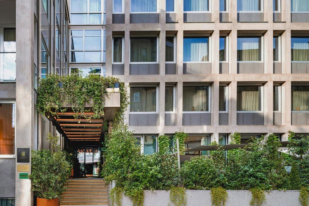 An open interior courtyard in a stripped concrete building with planting at ground level.